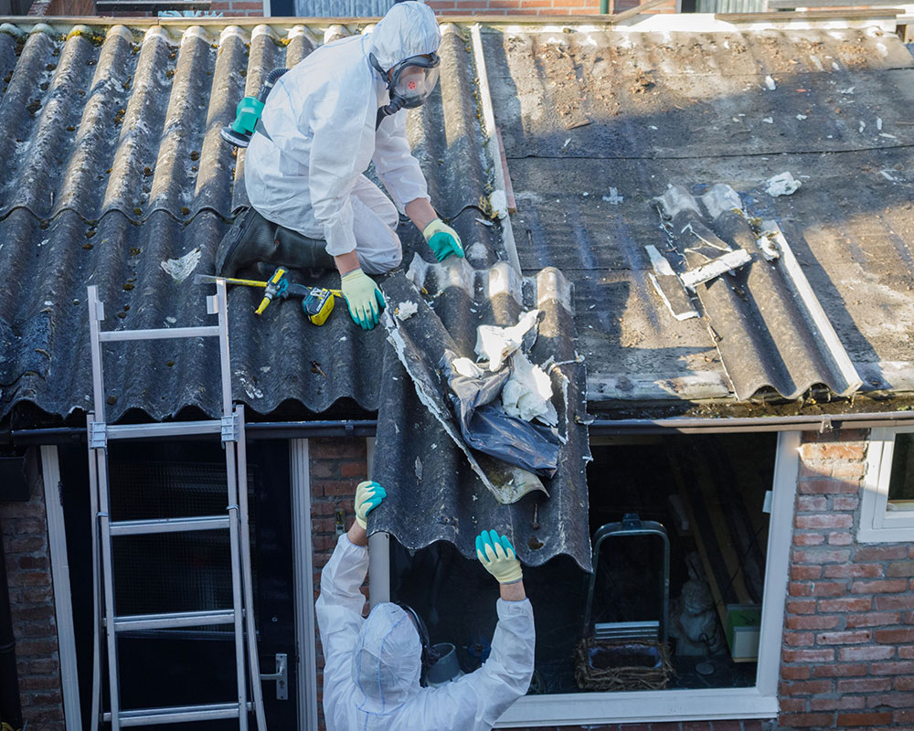 Clearaway team members in protective gear during asbestos removal